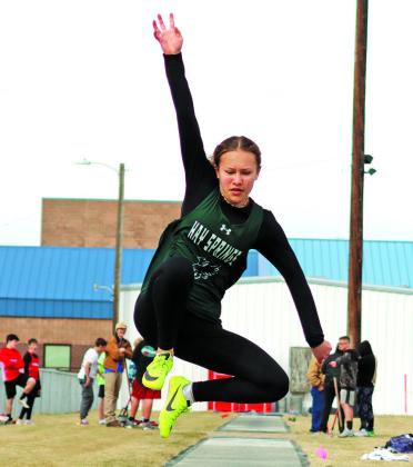 Photo by Scott Bidroski Freshman Alaina Raymer soars to her mark in the Long Jump. Raymer finished in seventh place in the event at the Chadron Twilight meet on Friday, April 19.