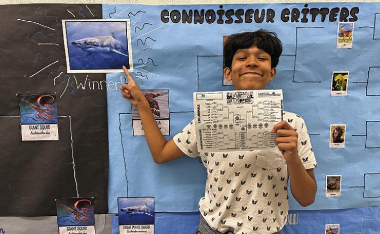 Photo by Amy Schmidt Joel Montenez-Rodriguez shows off his winning bracket for March Mammal Madness at Gordon-Rushville Middle School.