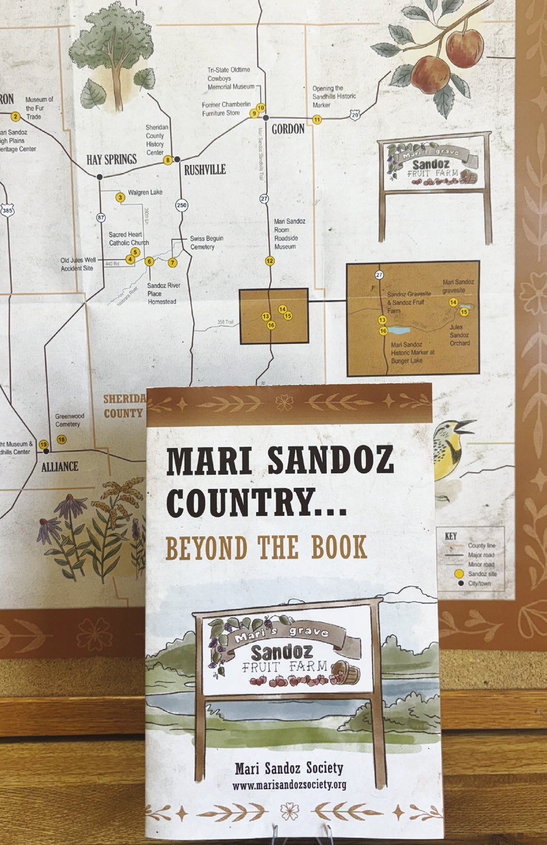 (Photo by Lisa Hare) New maps produced by the Mari Sandoz Society are modeled after the original “circle tour” maps designed in the 1970s, but with a modern twist. The new Sandoz Country tour map includes all the original locations, plus newer sites such as the High Plains Heritage Center in Chadron. (Copies of the map are available at the Sheridan Country Journal Star office.)
