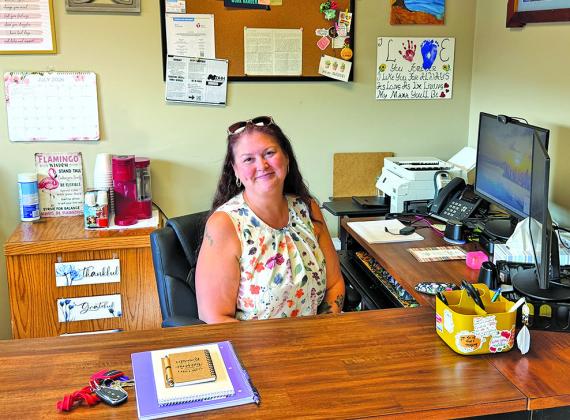(Photo by Scott Bidroski) Kaci Adonis, Operations Manager for the Safe At Home Gordon location, sits at her desk in the Gordon office. Safe At Home just opened their third location in the West area at 106 N. Main St. in Gordon.