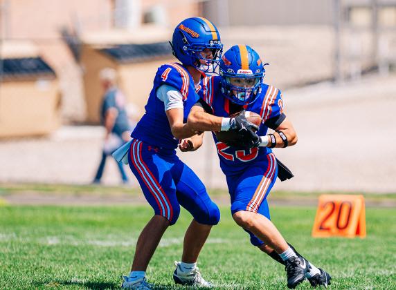 (Photo by Morgan Meisenheimer) G-R senior Trevyn Younkin takes the handoff from sophomore QB Khai Janssen. Younkin's 26 yard run scored the decisive touchdown to propel the Mustangs to a week three victory on the gridiron.