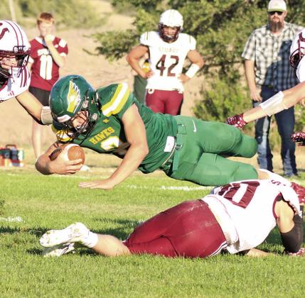 (Photo by Scott Bidroski) Hawks senior Tripp Buettner lunges forward for more yards against Stuart. Buettner finished his day with 76 yards rushing to lead the Hawks.