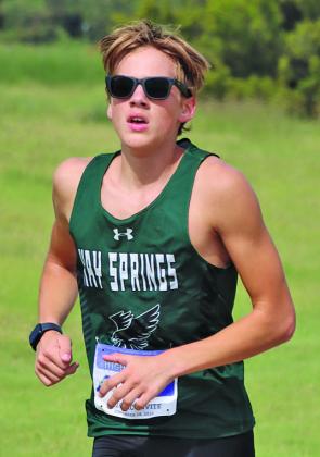 Photo by Scott Bidroski Hawks junior Grant Wellnitz runs through Laing Park in Alliance on Friday, September 18.