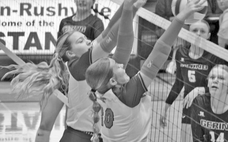 Photo by Michele Heck Mustangs Taleigh Starr and Emma Martins go up for a block against the Gering attackers on October 15.