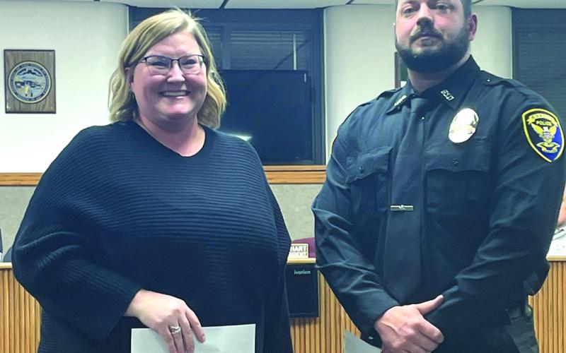 (Courtesy Photo) Gordon City Council President Alyssa DeHart (left) smiles after swearing in the newest officer to the Gordon Police Department, Tyler Mullanix, during the December 18 meeting.