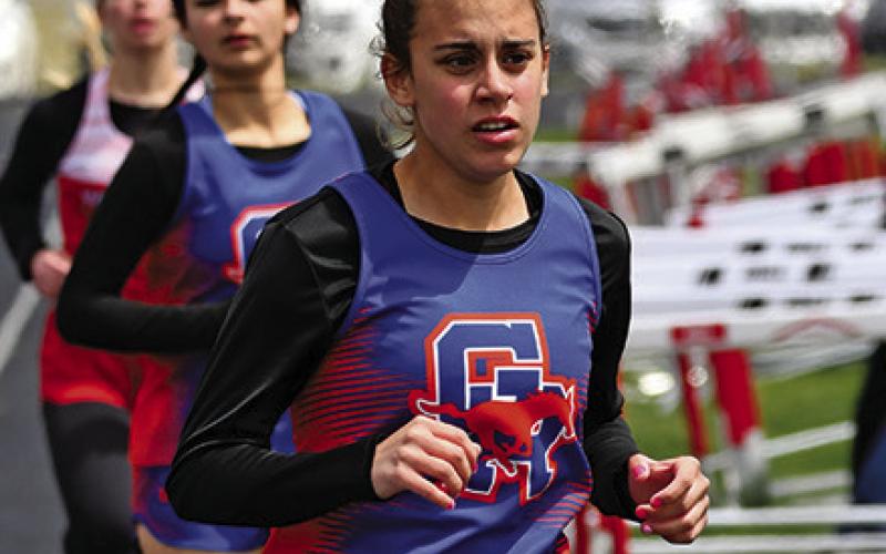 Photo by Melissa Grover Sophomore Valeria Benetiz rounds the corner during a lap during the 800 meter race on Friday, May 3.