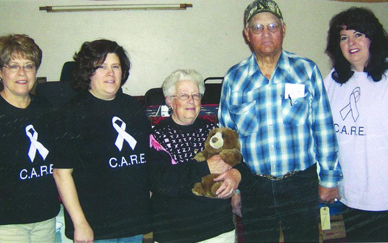 Courtesy Photo Nancy Scherr, Shelley Beguin, Mary &amp; Harold Hupp, and Terrie Jo Gibbons take a photo back in 2008 at the CARE Consignment Auction. Scherr and Gibbons are two of the original three members of the CARE Organization.
