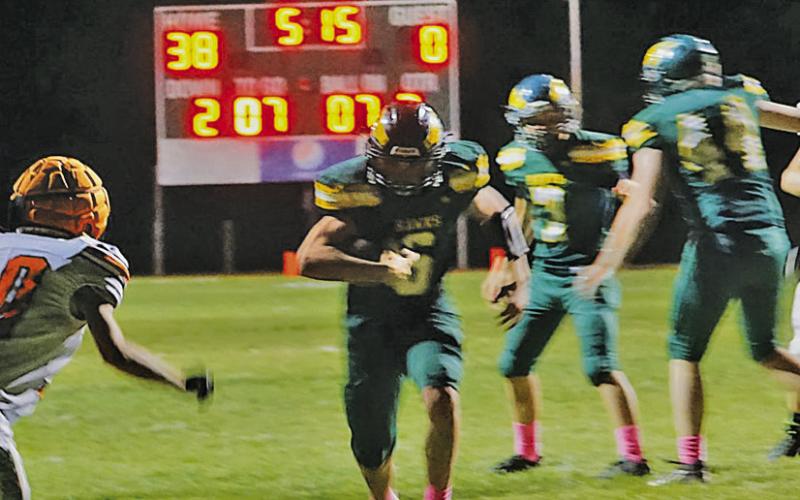 Photo by Michele Heck Sophomore Jaydub Turman scurries through a hole in the defensive line for the score. Turman would account for 4 total touchdowns in the 78-12 Hawks win.