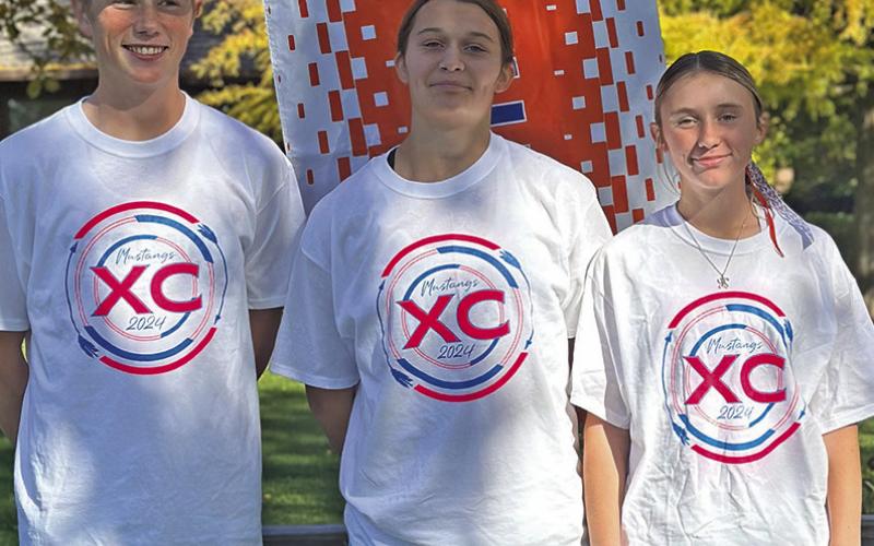 Photo by Amy Schmidt Luke Laws, Ashlyn Dehning, and Kynsleigh Krebs all represented the G-R Mustangs at State XC on October 25.
