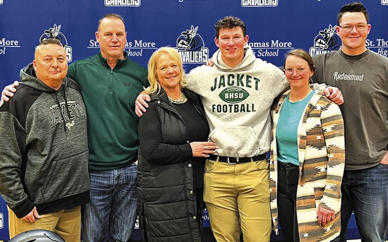 Courtesy Photo St. Thomas More senior and Sheridan County native Marcus Stouffer signed his Letter of Intent to play football at Black Hills State on February 22. Joining Stouffer for the occasion included: (L-R) St. Thomas More Coach Joe Gutierrez, Kelly Stouffer, Barb Stouffer, Marcus Stouffer, Maci Stouffer, and Max Stouffer.