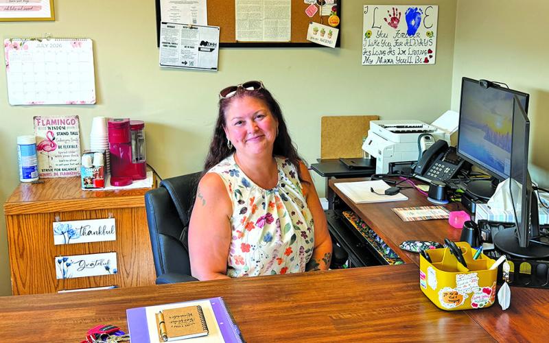 Photo by Scott Bidroski Kaci Adonis, Operations Manager for the Safe At Home Gordon location, sits at her desk in the Gordon office. Safe At Home just opened their third location in the West area at 106 N. Main St. in Gordon.