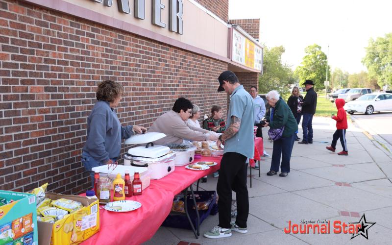 (Photo by Scott Bidroski) Community members work their way through the line for a delicious supper provided by the Gordon Theatre and it's volunteers.