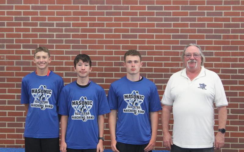 (Courtesy Photo) Robert Moore, Draven Russell, and Caden Sommers participated in the Masonic All-Star Marching Band held in Kearney, Neb. The trio are pictured here with Gordon-Rushville Band Director George Meng.