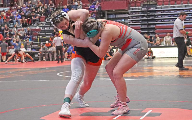 (Photo by Scott Bidroski) Heck engages her opponent, Joyah Tilberg from Rapid City Central High School, in the first period of the match on January 24.