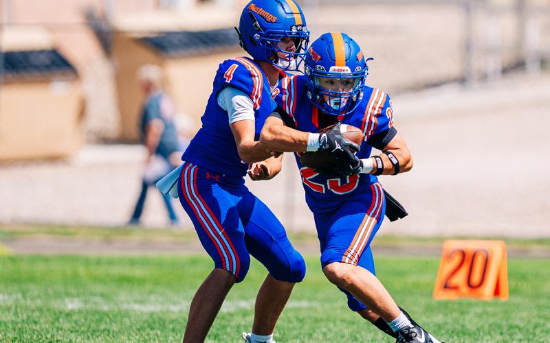 (Photo by Morgan Meisenheimer) G-R senior Trevyn Younkin takes the handoff from sophomore QB Khai Janssen. Younkin's 26 yard run scored the decisive touchdown to propel the Mustangs to a week three victory on the gridiron.