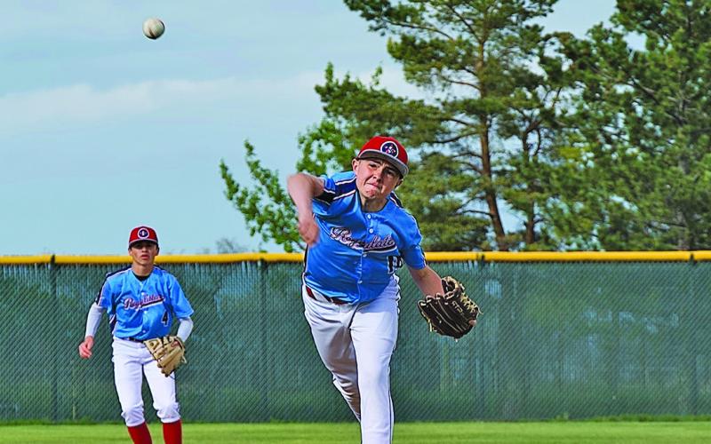 (Photo by Richae Malara) Eighth grader Liam Keracik delivers a pitch against the Chadron Juniors while fellow eighth grader Khai Janssen readies himself at shortstop. While not in high school yet, these two young men are key components of the Juniors team.