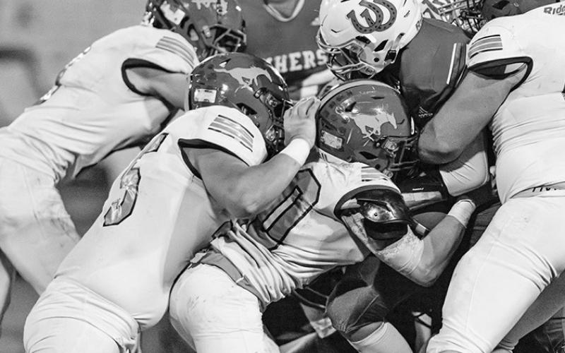 Photo by Morgan Meisenheimer The Mustang defense stops Amherst on fourth down during the 21-13 Mustang win on October 25.