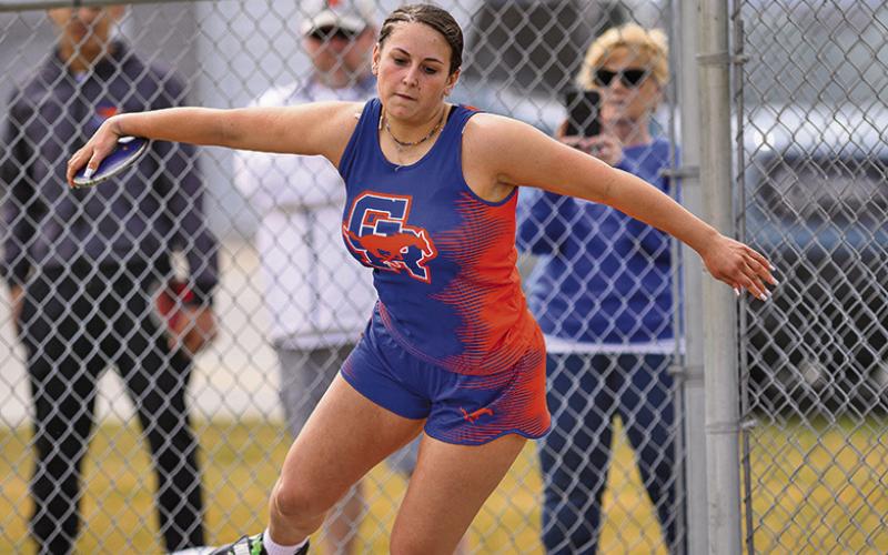 (Photo by Morgan Meisenheimer) Junior McKaley Grover winds up before launching her first place throw in the Discus. Grover was one of three Mustangs who earned a gold at the Binfield Invitational on Friday, March 28.