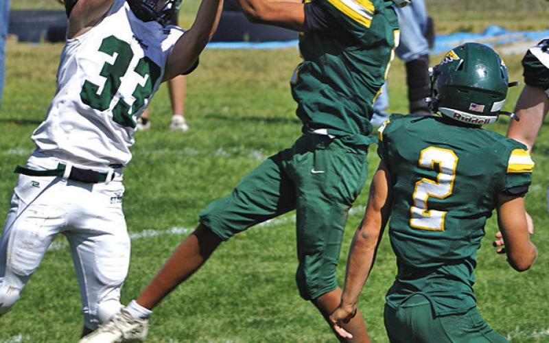 (Photo by Michele Heck) Freshman Arian Mata skies for the interception over the Creek Valley Storm receiver in the Hawks 80-12 win on Friday, September 19.