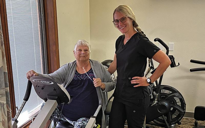 Photo by Scott Bidroski Hay Springs resident Dottie Peters (left) works with Physical Therapy Assistant Brianna Tonjes in the Rehabilitation Clinic at Pioneer Manor in Hay Springs. Tonjes, along with Physical Therapist Rebecca Wellnitz provide rehab services at Pioneer Manor on a daily basis.