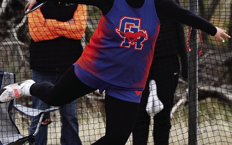 Photo by Melissa Grover McKinley Grover launches the discus for her second gold medal on the day to punch her ticket to the NSAA State Track Meet at Burke Stadium in Omaha, Neb.