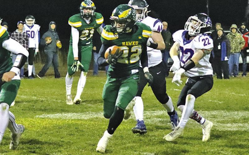 Photo by Scott Bidroski Senior Dylan Raymer sheds a tackles en route to yet another big gain against Arthur County. Raymer finished with 4 rushing touchdowns and 143 yards of rushing.