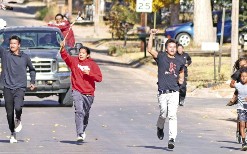 Photo by Scott Bidroski Ketch Big Crow, Cody Two Bulls, Isnala White Bull, and Chevy Cadwell finish the relay run down Oak Street in Gordon on Wednesday, October 23. These young men were part of a group who ran from Pine Ridge, S.D. to Gordon in memory of two young men who died recently in a car accident.