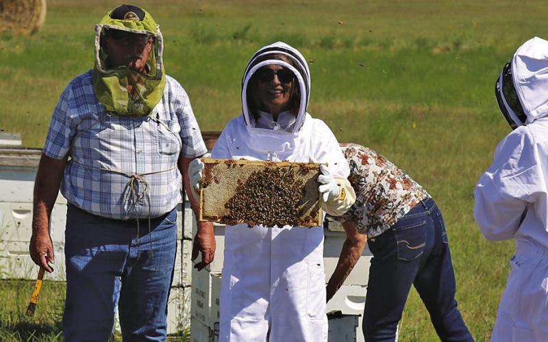 Photo Courtesy of Senator Deb Fischer’s Office Nebraska State Senator Deb Fischer snaps a photo while working bees with Hay Springs resident Ed McDonald on Tuesday, August 12. Fischer as in town to visit with the McDonald’s about their independent, wholesale beekeeping business that has been operating for 37 years.