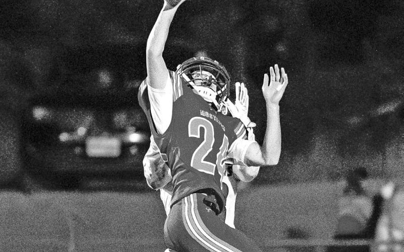 Photo by Morgan Meisenheimer Senior Austin Child elevates to knock away the pass from the Badger receiver.