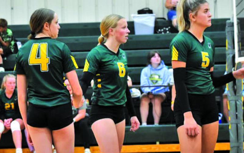 Courtesy Photo Kya Binger, Reese Varvel, and Julia Russell await the serve from Banner County on September 3.