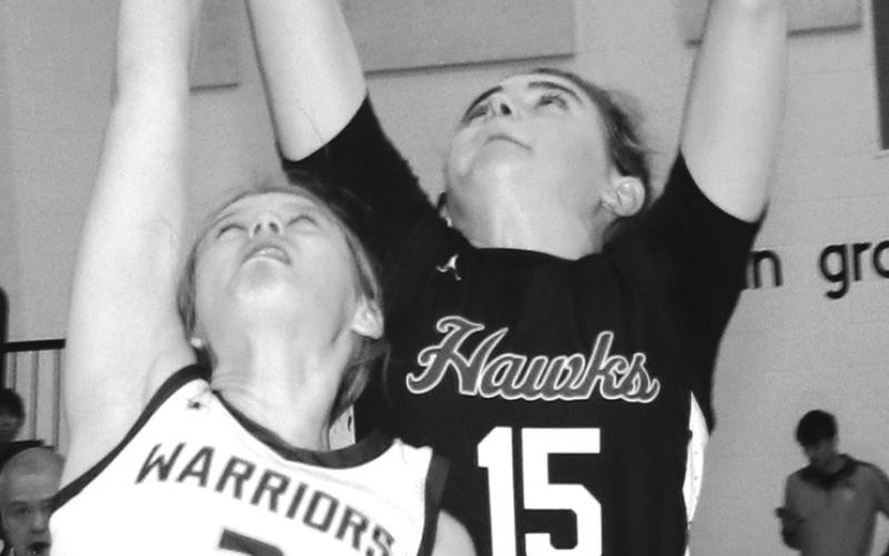 Photo by Taylor Risse, Bennett County Booster Sophomore Julia Russell goes up and over the Warrior defender for a rebound. Russell would finish the contest with 12 rebounds and 17 points.