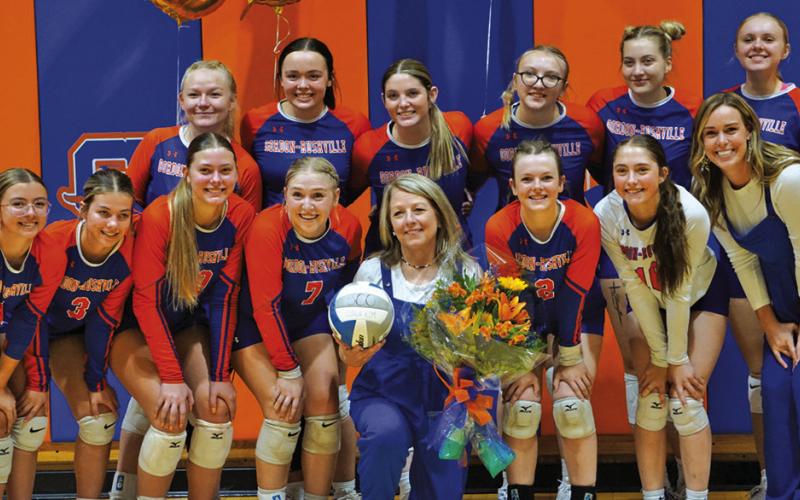 Photo by Michele Heck The Gordon-Rushville Volleyball team presented Coach Kim Campbell flowers and a signed volleyball to celebrate her 500th win as a volleyball coach. Coach Campbell became the 35th coach in Nebraska High School Volleyball history to win 500 matches with her win over Ainsworth on Thursday, September 17. Read the full story on Page 7!