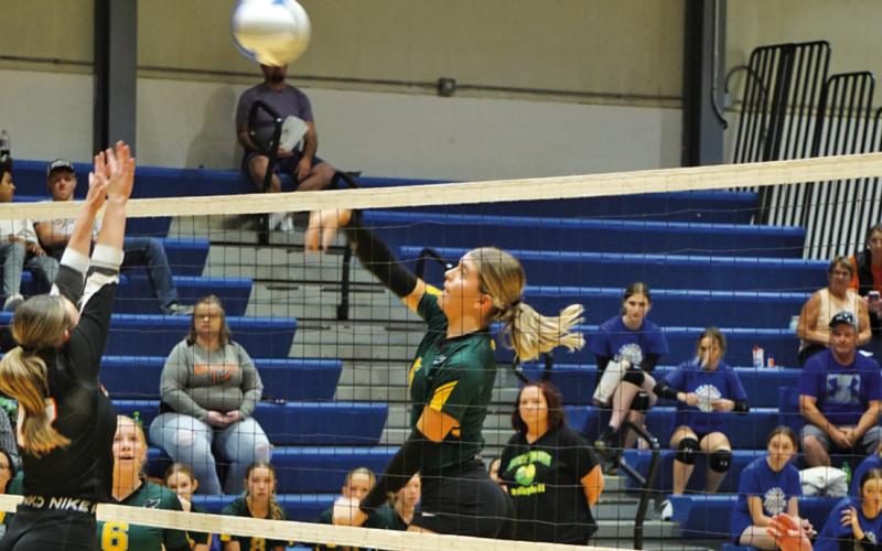 Photo by Michele Heck Junior Julia Russell fires a shot against Crawford at the G-R Quad on Saturday, September 14. The Hawks would win the match against the Rams 2-0.