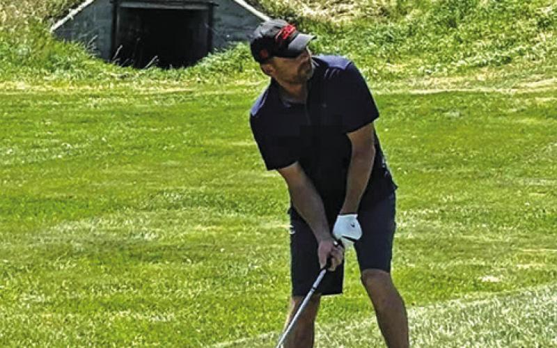 Photo by Lisa Merritt Brant Buettner takes a shot during a round at the Hay Springs Golf Course Tournament.