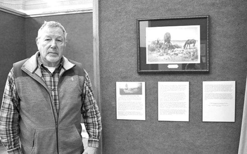 Photo by Molly Langhorst, Chadron State College Jerry Underwood poses by a piece of his private collection in “The West as They Saw It” on display in the Mari Sandoz High Plains Heritage Center, Jan. 22, 2024.