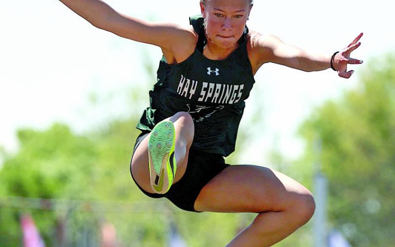 Photo by Jeremy Buss, Jeremy Buss Photography Freshman Alaina Raymer soars through the eastern Nebraska air in the Class D Long Jump at the Nebraska State Track Meet.