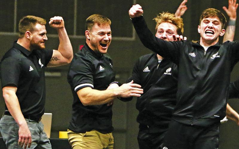 Courtesy Photo Chadron State Wrestling Head Coach Brett Hunter and the Eagles celebrate after winning a dual against Adams State that clinched a share of the Rocky Mountain Athletic Conference title. The Eagles went 8-0 in conference duals on way to winning the conference title.