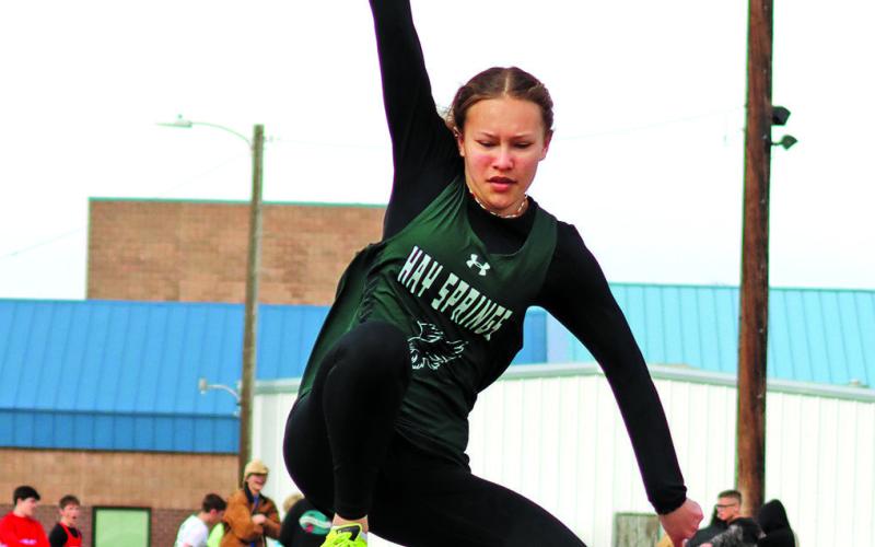 Photo by Scott Bidroski Freshman Alaina Raymer soars to her mark in the Long Jump. Raymer finished in seventh place in the event at the Chadron Twilight meet on Friday, April 19.