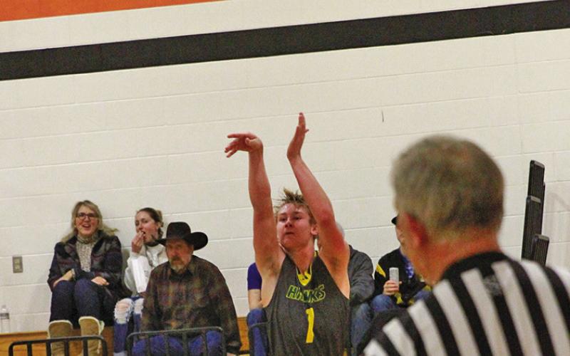 (Photo by Bev Lee) Dylan Young fires a jumper that would seal the deal for his 1,000 point. The bucket came against Morrill on Saturday, January 25 in the PANCO tournament.