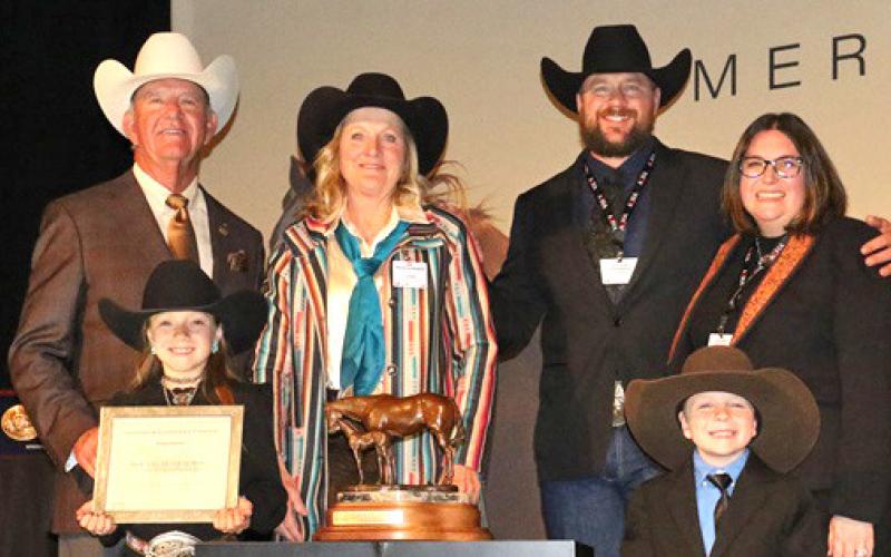 Courtesy Photo BOXO Quarter Horses, which is based in central Sheridan County, was named the AQHA 2023 Top Money-Earning Ranching Heritage Breeder of the Year. Included in the photo are: (LR) 2023 AQHA President Ken Banks, Tenley Ostrander, Jecca Ostrander, Stetson Ostrander, Courtney Ostrander, and Jensen Ostrander. Not pictured: Cash Ostrander