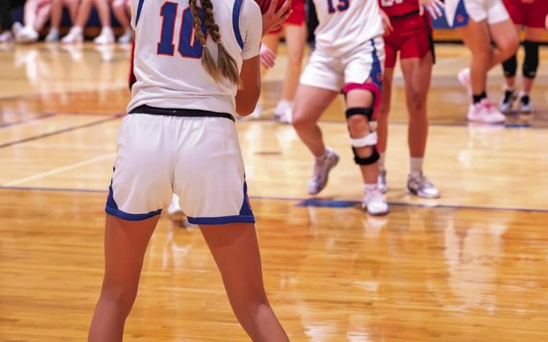 (Photo by Richae Malara) Junior Rarity Cournoyer (#10) lines up the three point attempt while sophomore Mikaylee Campbell works for position in the paint. Cournoyer led the Mustangs in scoring this week with 26 points in the two games.