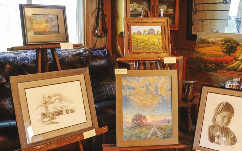 (Photo by Nicole Louden) Local painter Rick Yusten captures the Sandhills’ vaulted skies wide vistas and unique culture in his paintings exhibited at the recent Spade Ranch Reunion in Ellsworth.