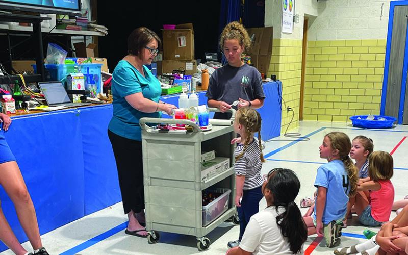 Photo by Tessa Hurlburt Lisa Janssen demonstrating an experiment at the Gordon summer program.
