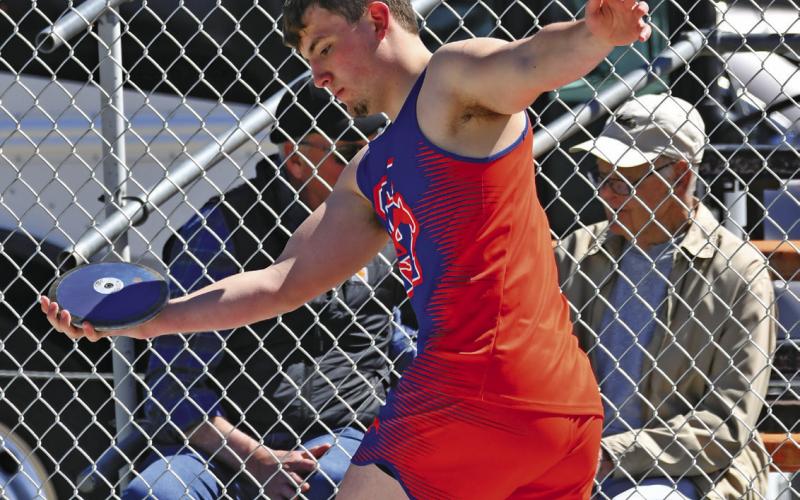 Photo by Melissa Grover Senior Colton Archibald steadies himself prior to sending the discus down range in Mitchell. Archibald would finish in 9th place in the event.