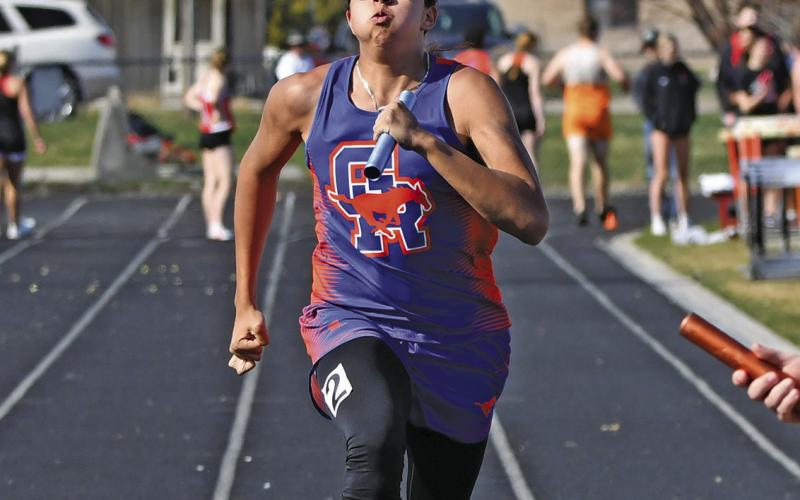 Photo by Melissa Grover Senior Louis Martin digs in deep for the final leg of the 4x100 meter relay race in Mitchell on Thursday, April 4.