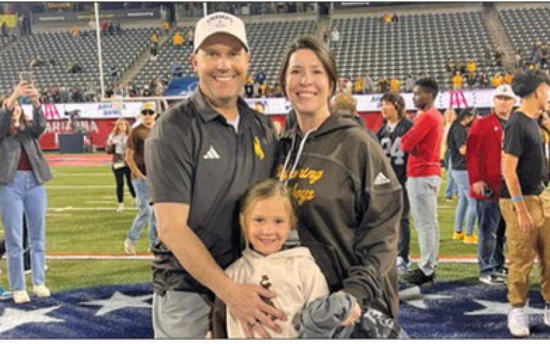Shannon Moore (left) takes a photo with his wife Lindsay (right) and daughter Mackenzie (center) following the University of Wyoming’s bowl win over Toledo in 2023. The Cowboys took down the Rockets 16-15 in the Barstool Sports Arizona Bowl with Moore on staff as the Tight End and Fullbacks Coach.