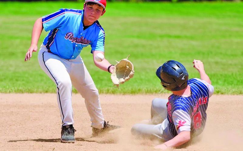 Photo by Richae Malara Seventh grader Keagan Sommers takes the throw down from his catcher during a contest against Kimball on Saturday, June 28.