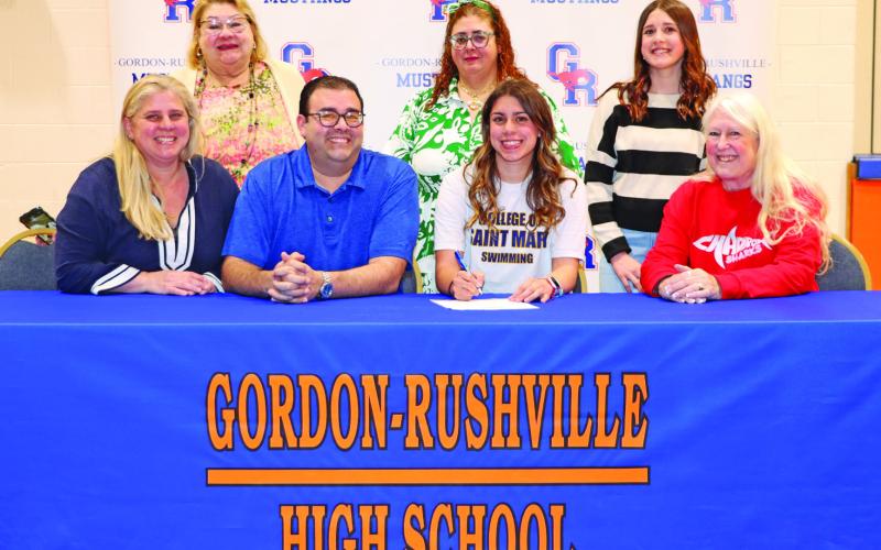Photo by Scott Bidroski Gordon-Rushville High School senior Valeria Benitez-Socarres signed her Letter of Intent to swim collegiately at the College of Saint Mary’s on Monday, March 23. Benitez-Socarres was joined by her family and coach for the big event. Those pictured include: Sylmarie Socarres, Arelis Quintones, Jose Benitez, Arelis Benitez, Valeria Benitez-Socarres, Fabiola Benitez-Socarres, and Barb McCartney.