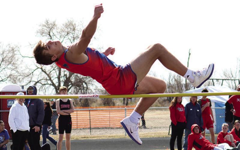 Sophomore Daniel Martins elevates over the bar in the High Jump in Bayard. Photo by Scott Bidroski