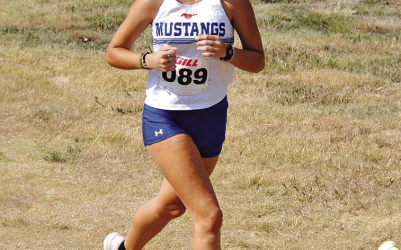 Photo by Chris Heiser Senior Iris Clark cruises her way to the finish line during the Chadron State College Invitational on Friday, September 13.